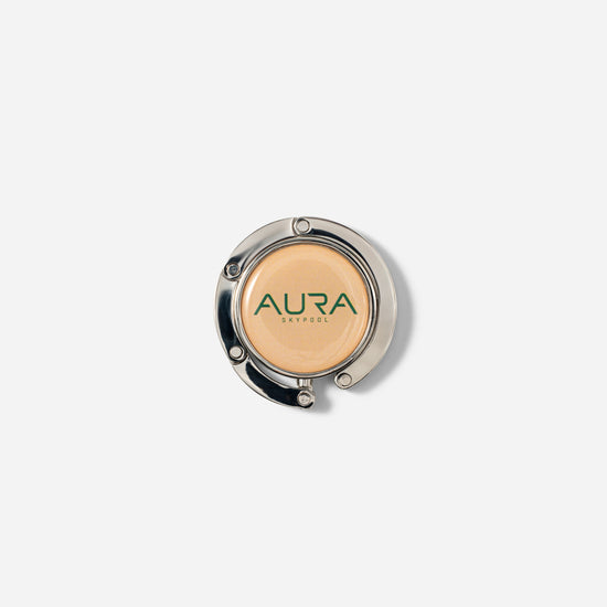 AURA Bag Hanger folded flat showing the AURA Skypool enamel disc