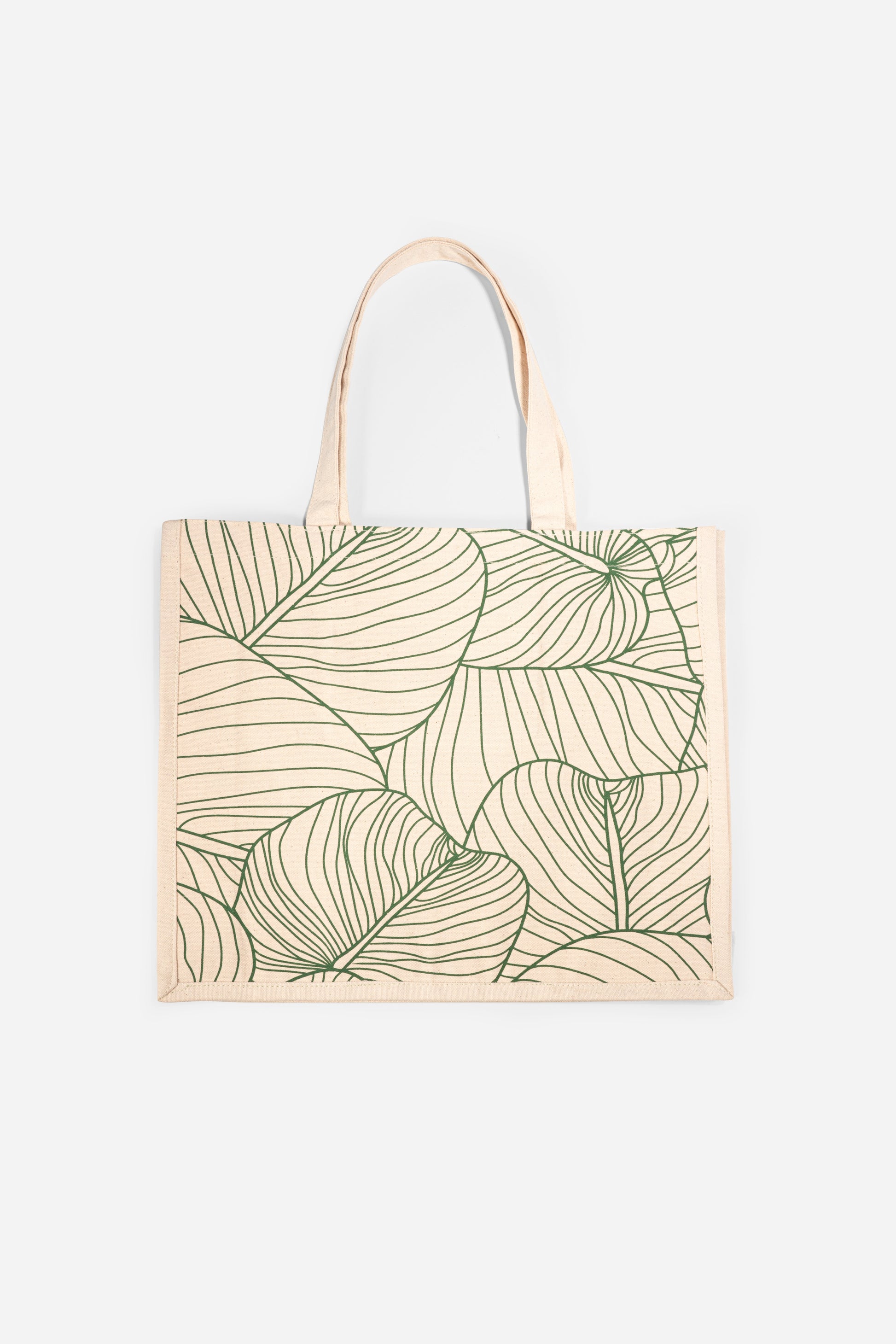 The AURA Canvas Tote in natural canvas with green palm leaf line-art print, front view