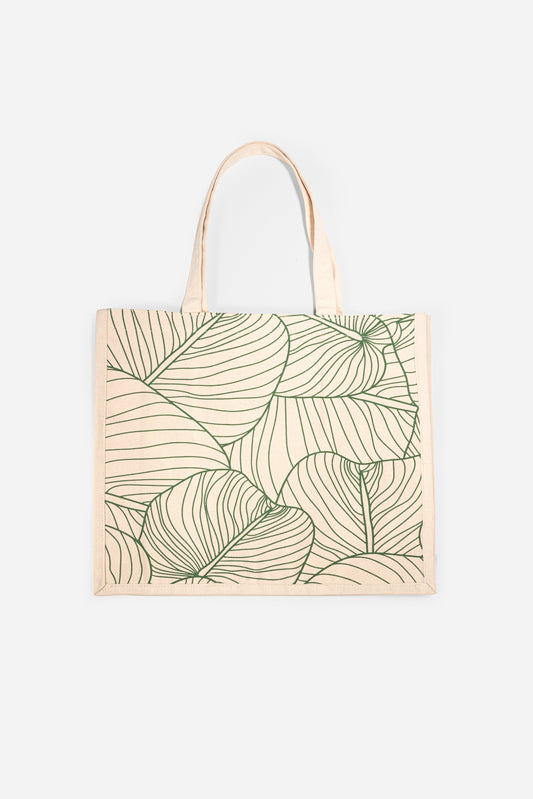 The AURA Canvas Tote in natural canvas with green palm leaf line-art print, front view