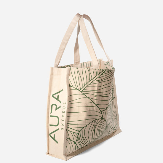 Side view of The AURA Canvas Tote showing AURA Skypool logo printed along the panel
