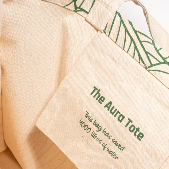 Close-up of The AURA Canvas Tote fabric patch highlighting its water-saving production