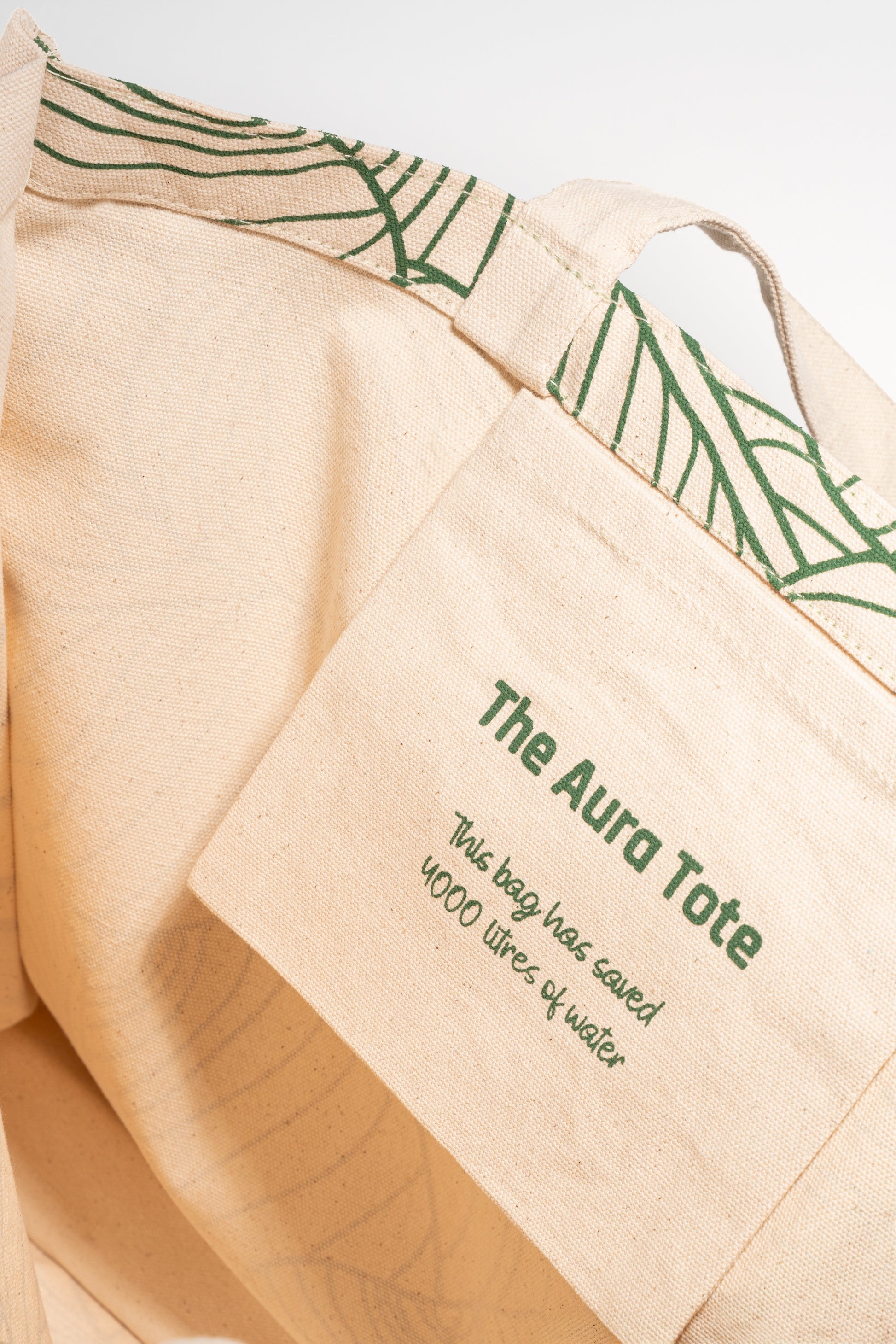Close-up of The AURA Canvas Tote fabric patch highlighting its water-saving production