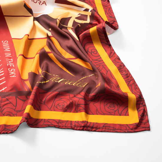AURA Loves Jamelia Silk Scarf, draped close-up showing the Jamelia signature and rose print