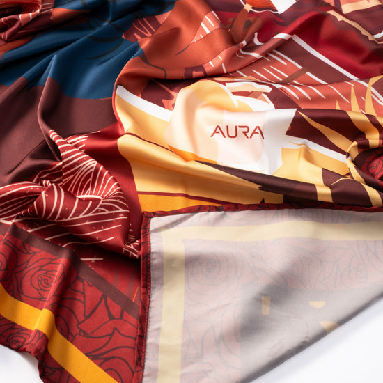 AURA Loves Jamelia Silk Scarf, bunched showing the AURA label and rose print reverse