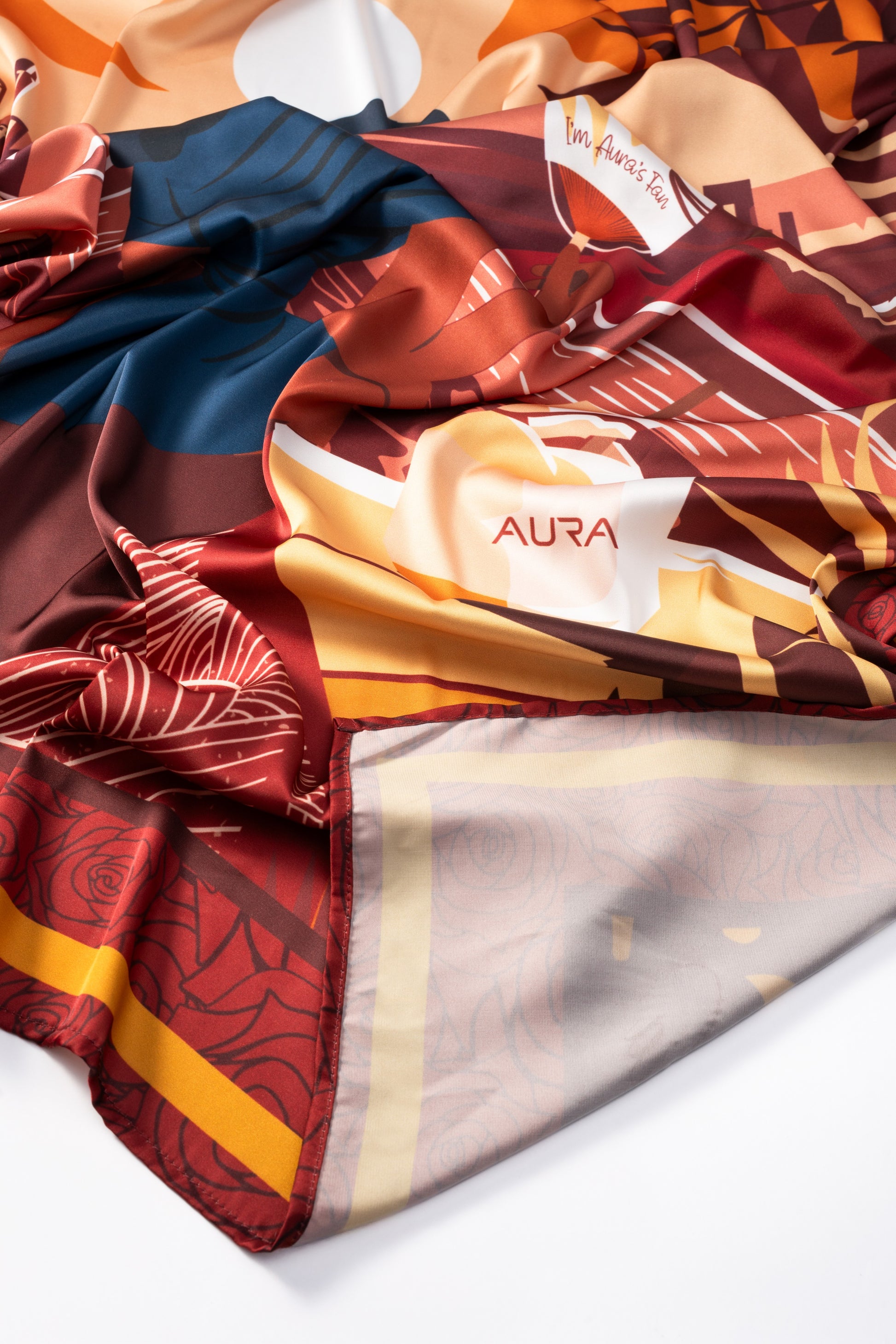 AURA Loves Jamelia Silk Scarf, bunched showing the AURA label and rose print reverse