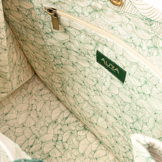 Open interior of AURA Signature Tote Bag with matching leaf-print lining and zip pocket