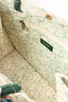 Open interior of AURA Signature Tote Bag with matching leaf-print lining and zip pocket