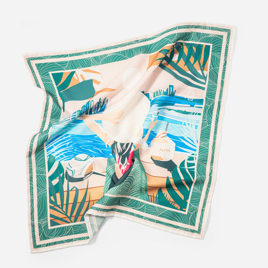 AURA silk scarf accessory in green and blue palm print shown as a styling detail flat lay