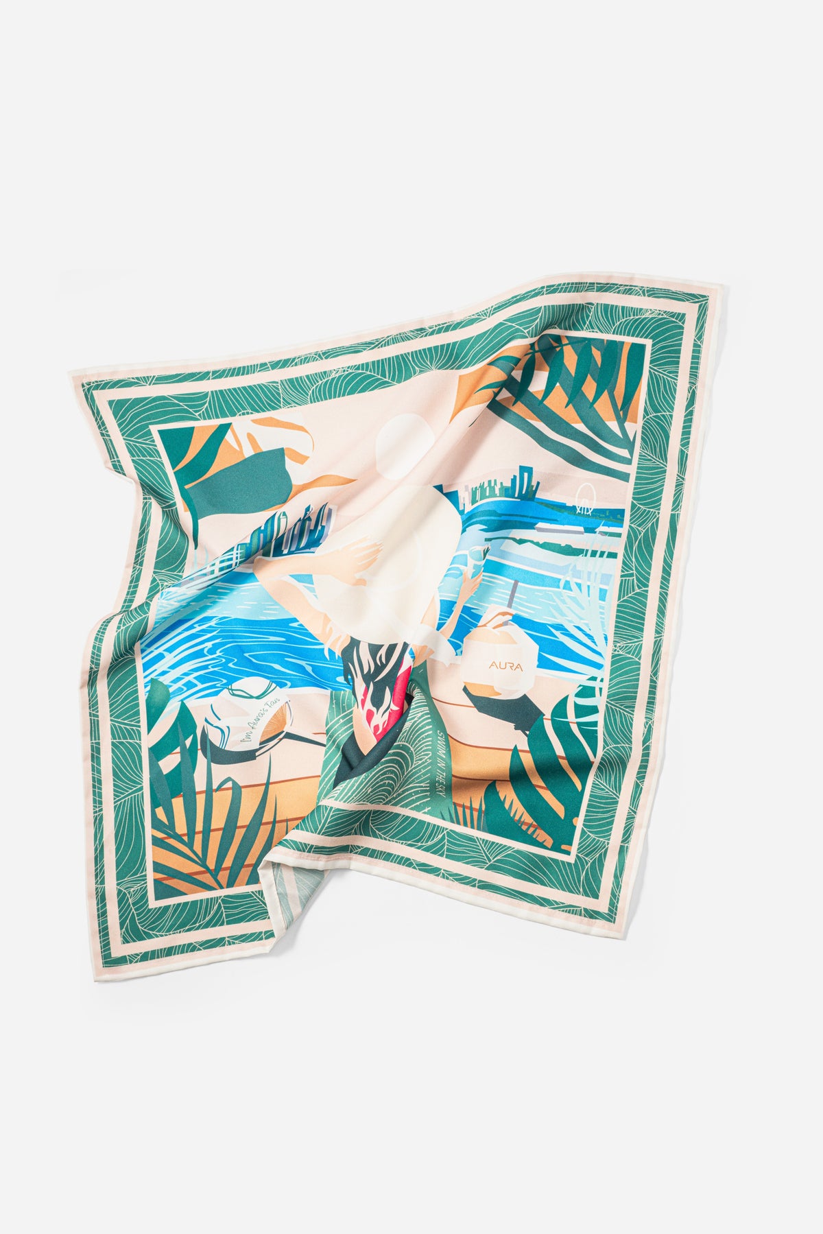 AURA silk scarf accessory in green and blue palm print shown as a styling detail flat lay