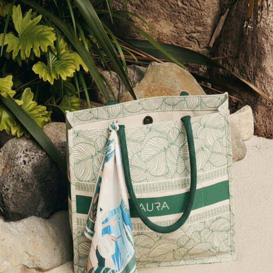 AURA Signature Tote Bag in green leaf print styled outdoors with a coordinating AURA scarf