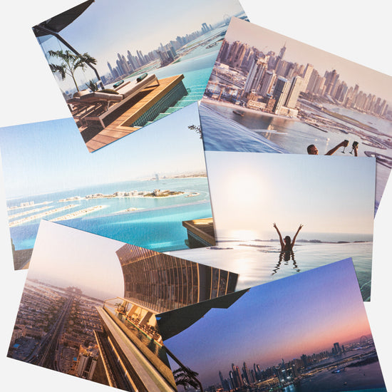 AURA Skypool postcard set, six cards fanned out showing pool and skyline views