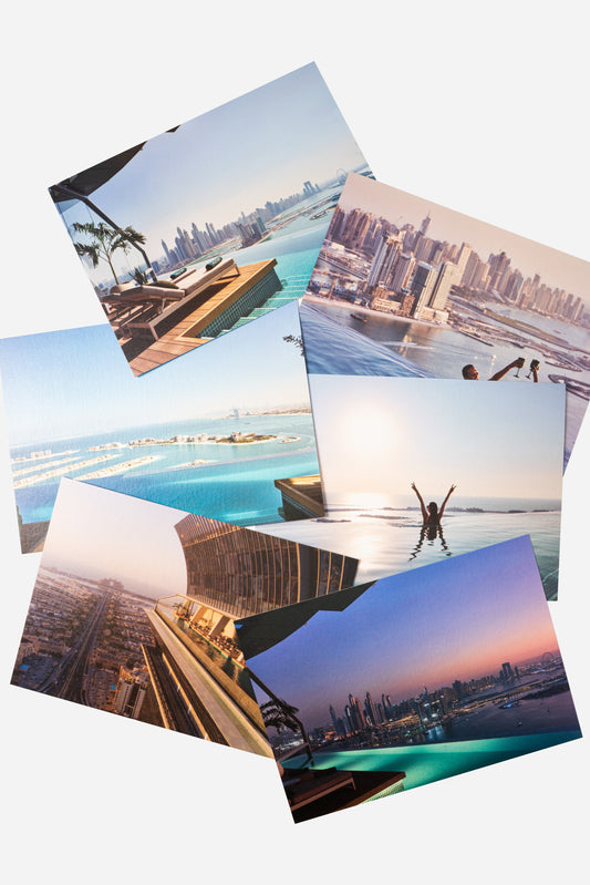 AURA Skypool postcard set, six cards fanned out showing pool and skyline views