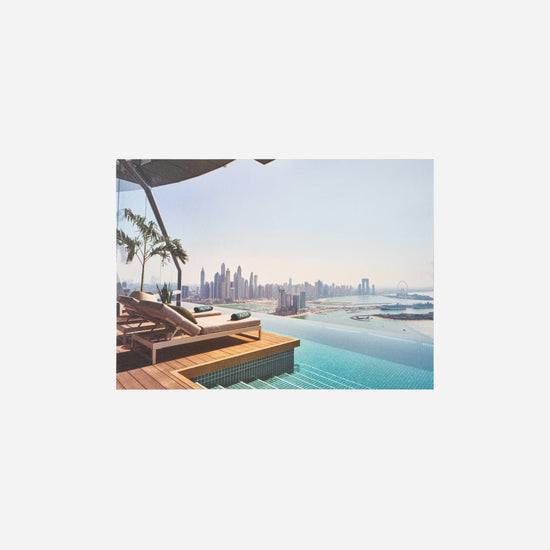 AURA Skypool postcard, poolside loungers overlooking the Dubai Marina skyline