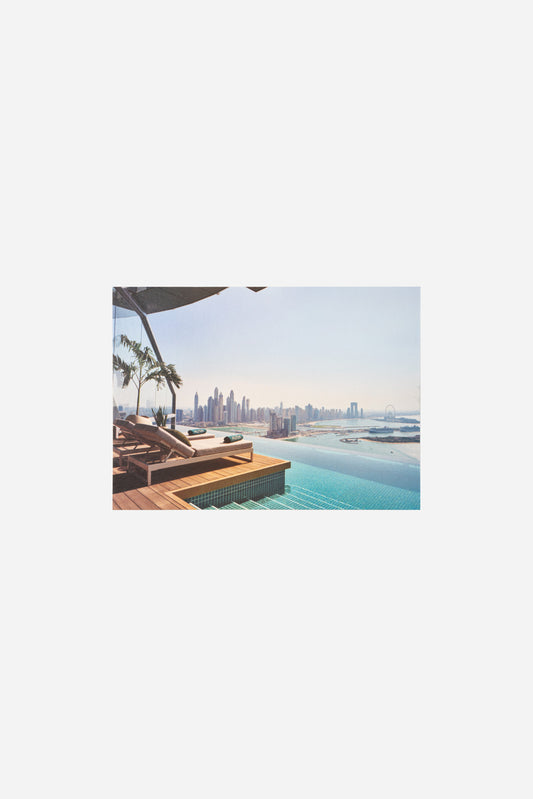 AURA Skypool postcard, poolside loungers overlooking the Dubai Marina skyline
