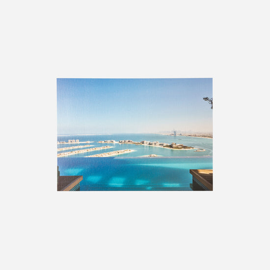 AURA Skypool postcard, aerial view of Palm Jumeirah with Burj Al Arab in the distance