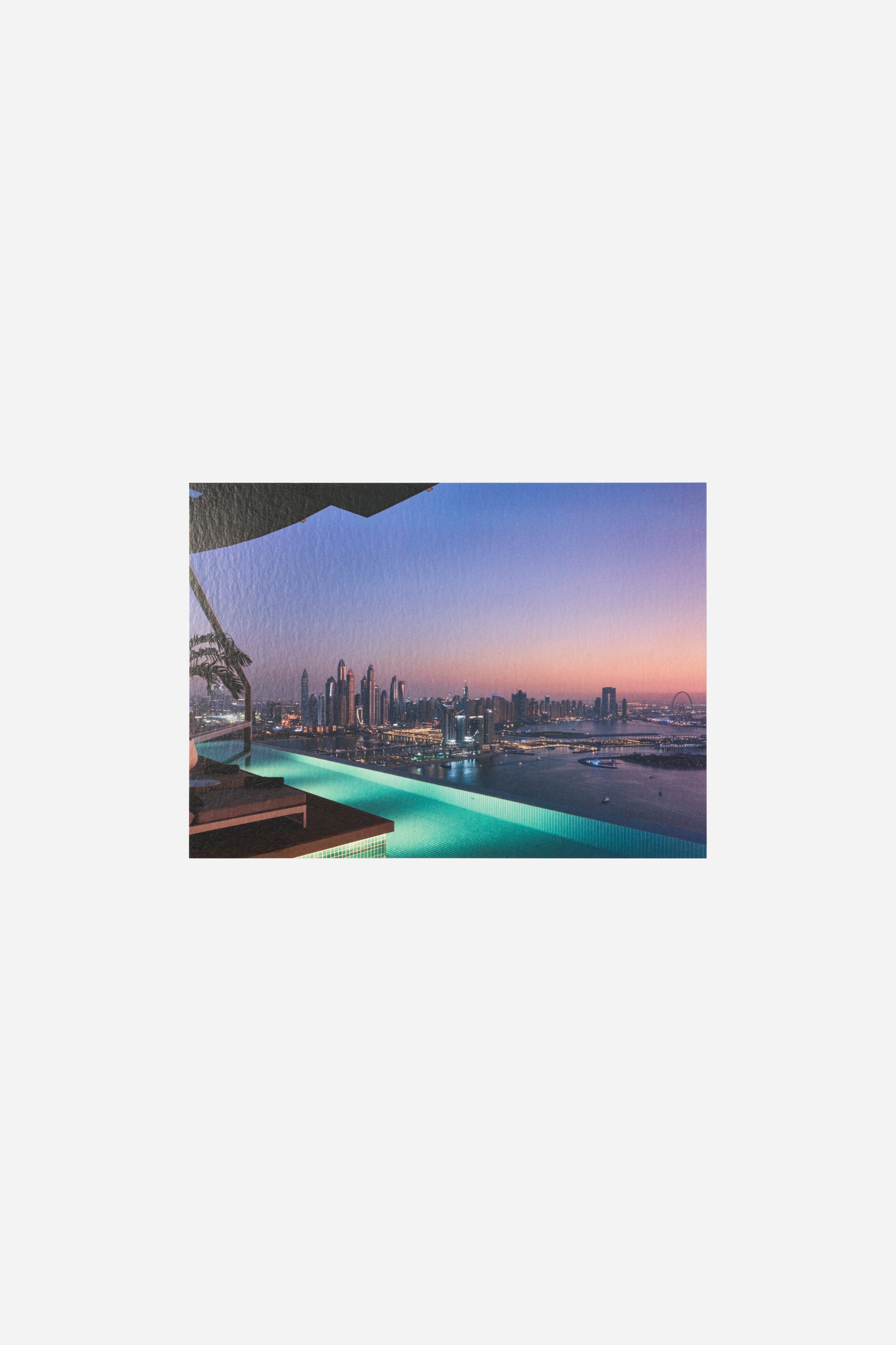 AURA Skypool postcard, pool edge glowing teal at sunset over the skyline