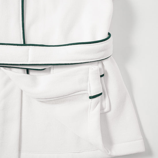 AURA woven label and green piping detail on baby bathrobe pocket