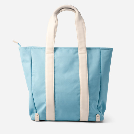 Back view of AURA Beach Bag Whisper Blue showing cream handles and side zip pull