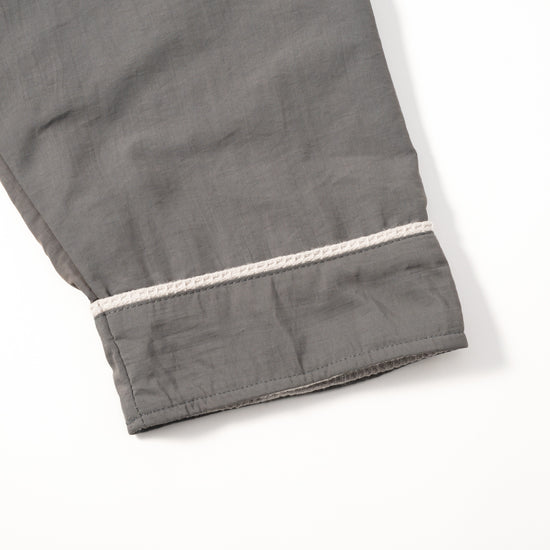 Cosy Robe charcoal grey fabric close-up showing ivory cuff piping