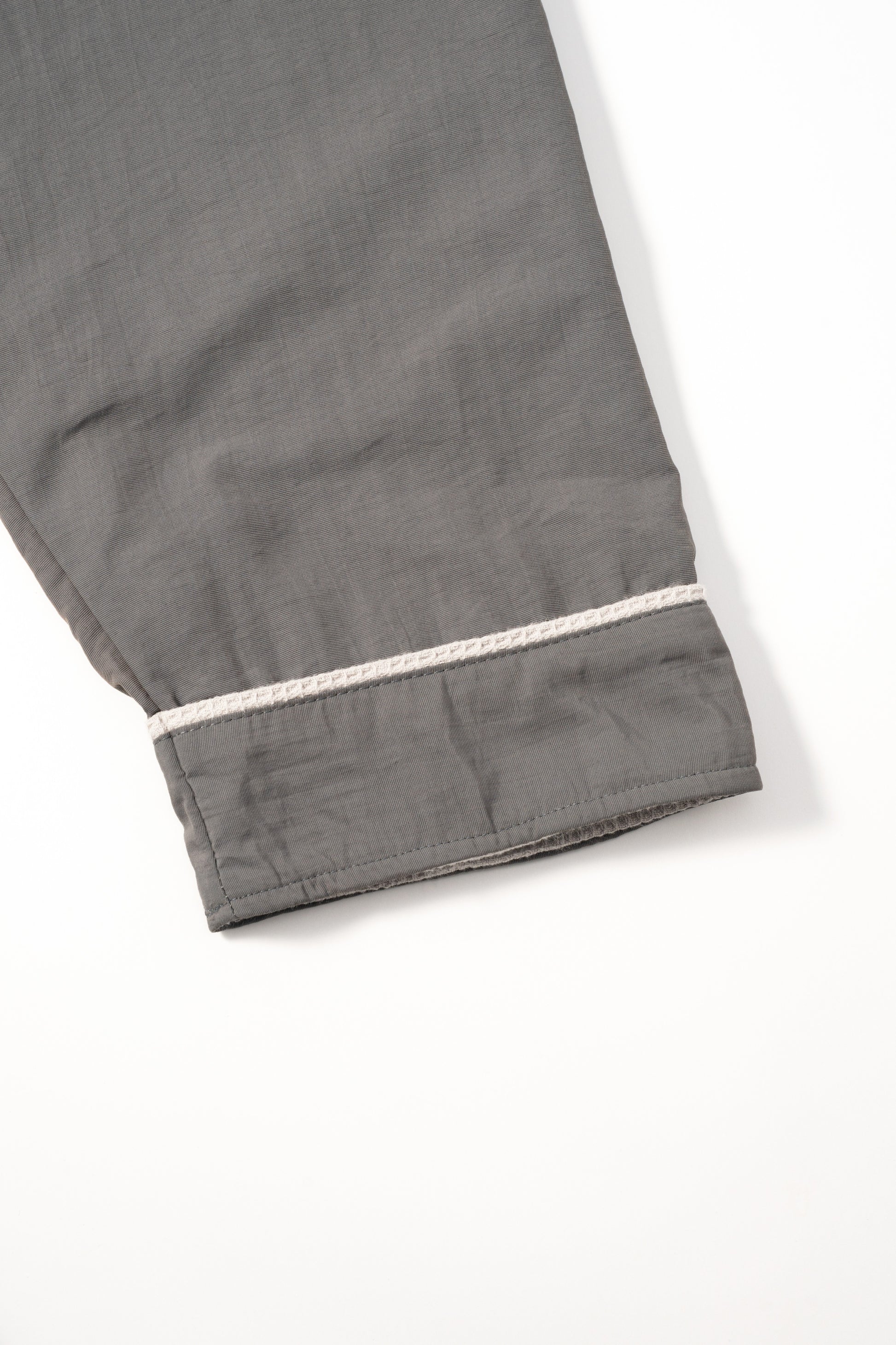 Cosy Robe charcoal grey fabric close-up showing ivory cuff piping