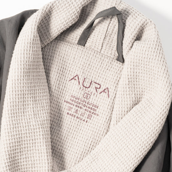 AURA Skypool care label on Cosy Robe, 100% nylon outside, 100% cotton inside, made in UAE