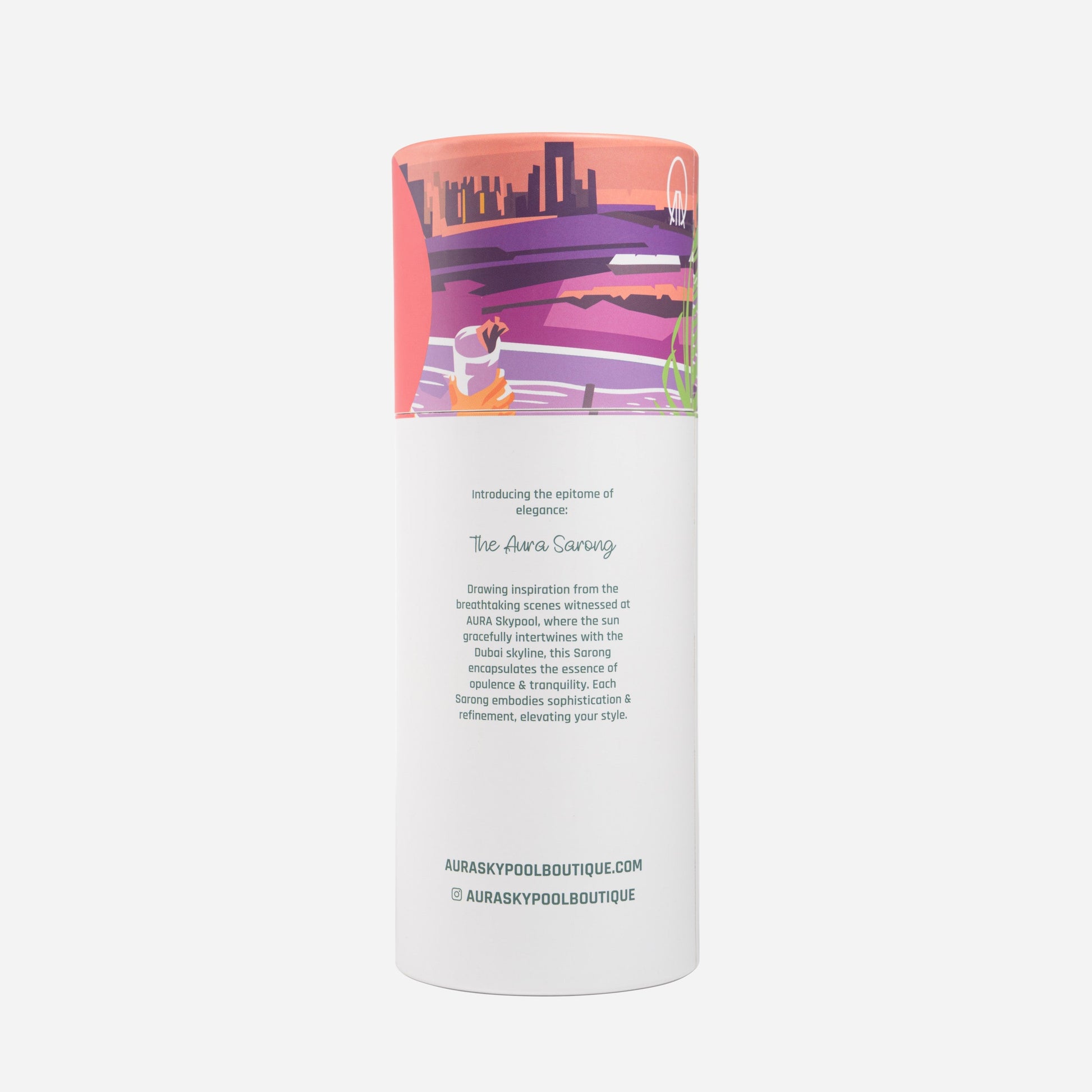 Dubai Skyline Sarong in coral, tube packaging back reading 'The AURA Sarong' with brand story text