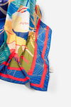 Dubai Skyline Sarong in indigo, draped close-up showing silk print and AURA label