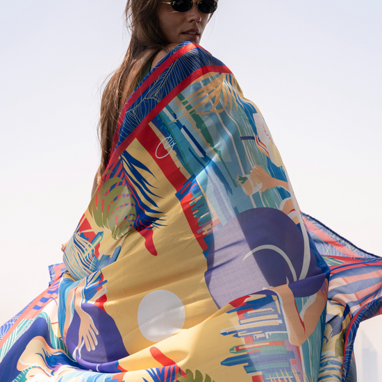 Dubai Skyline Sarong in indigo, wrapped and wind-blown on a Dubai rooftop