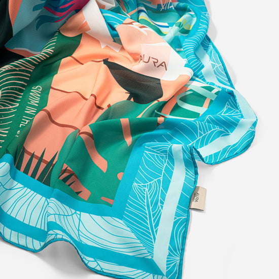 Dubai Skyline Sarong in sky blue, draped close-up showing silk print and AURA label