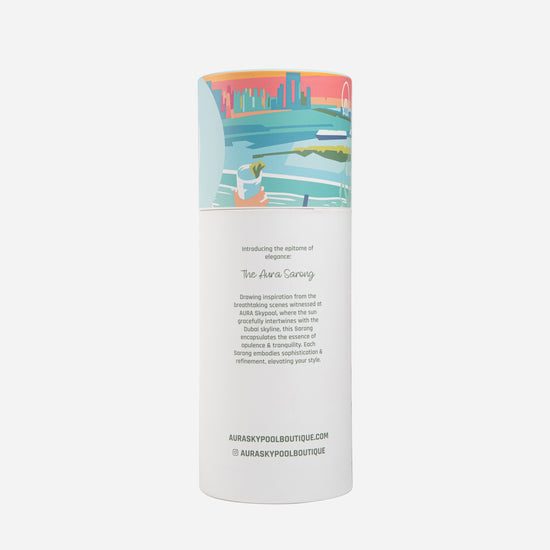 Dubai Skyline Sarong in sky blue, tube packaging back reading 'The AURA Sarong' with brand story text