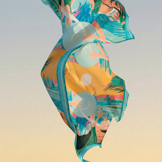 Dubai Skyline Sarong in sky blue, floating over the ocean at sunset