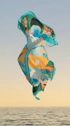 Dubai Skyline Sarong in sky blue, floating over the ocean at sunset