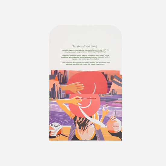 Dubai Skyline Mini Scarf in Coral, packaging card with AURA Accent Scarf description