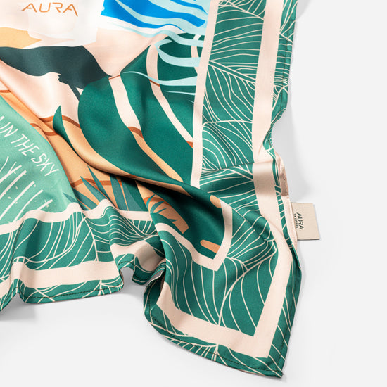 Dubai Skyline Silk Scarf in Green, draped close-up showing the AURA woven label