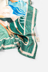 Dubai Skyline Silk Scarf in Green, draped close-up showing the AURA woven label
