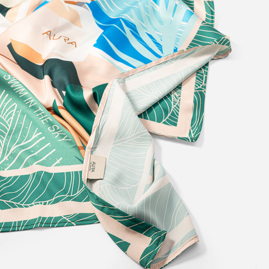 Dubai Skyline Silk Scarf in Green, draped showing the mint reverse border print