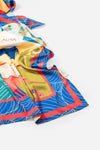 Dubai Skyline Silk Scarf in Indigo, draped close-up showing the AURA woven label