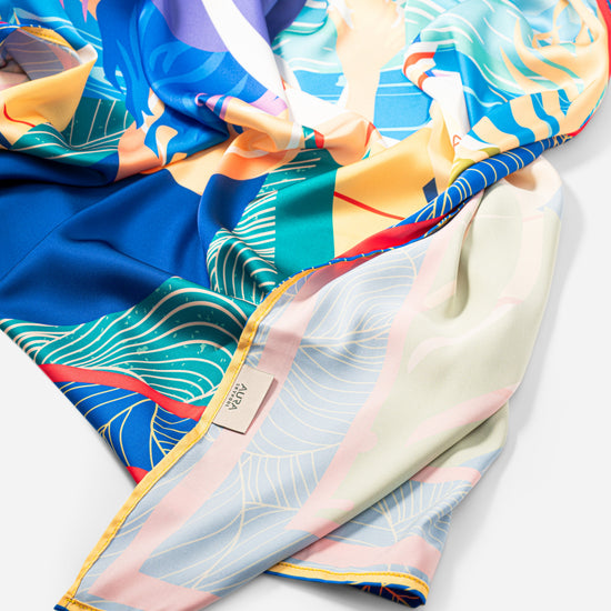 Dubai Skyline Silk Scarf in Indigo, bunched showing the pale reverse border print