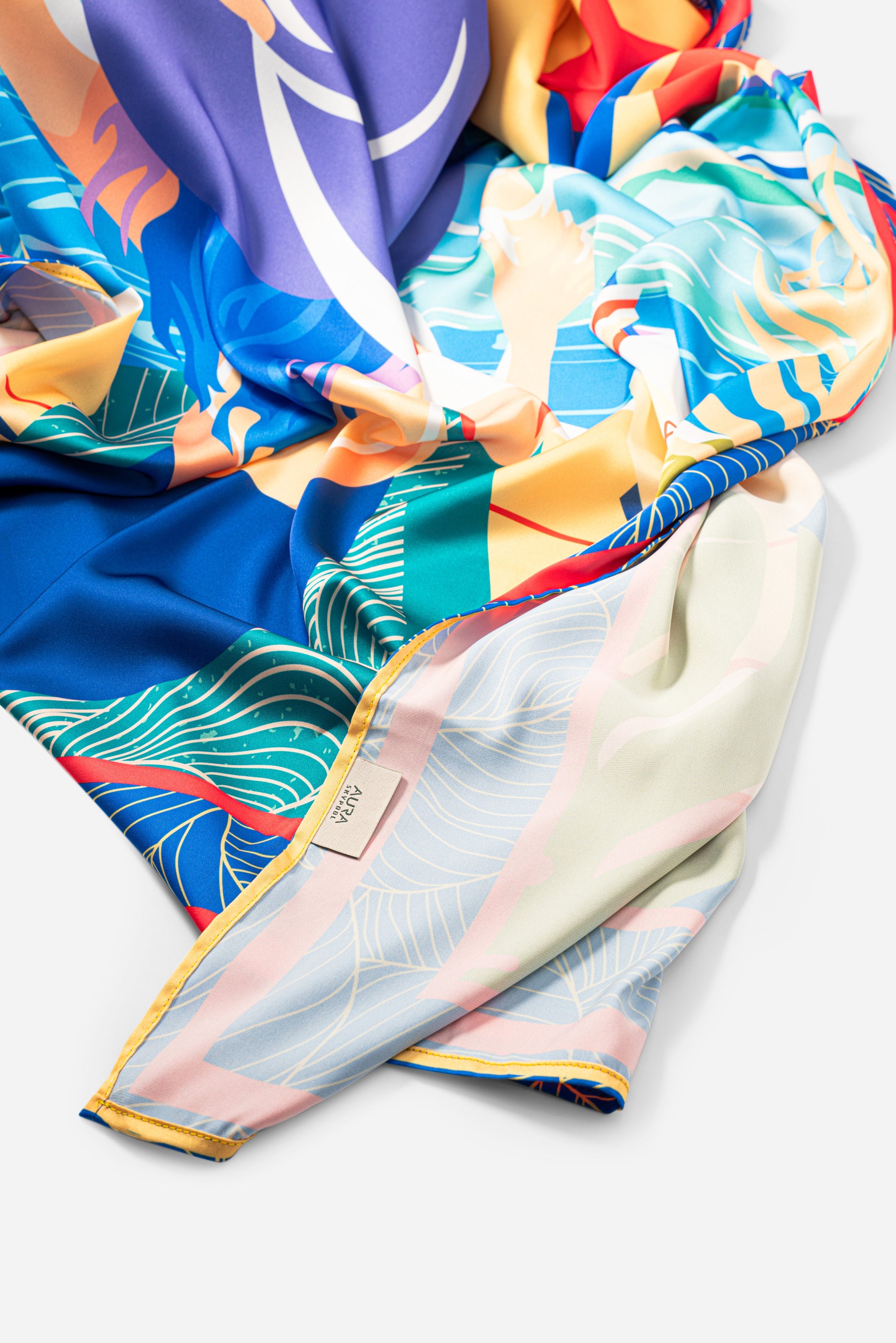 Dubai Skyline Silk Scarf in Indigo, bunched showing the pale reverse border print