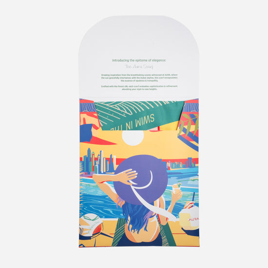 Dubai Skyline Silk Scarf in Indigo, packaging envelope with AURA scarf description
