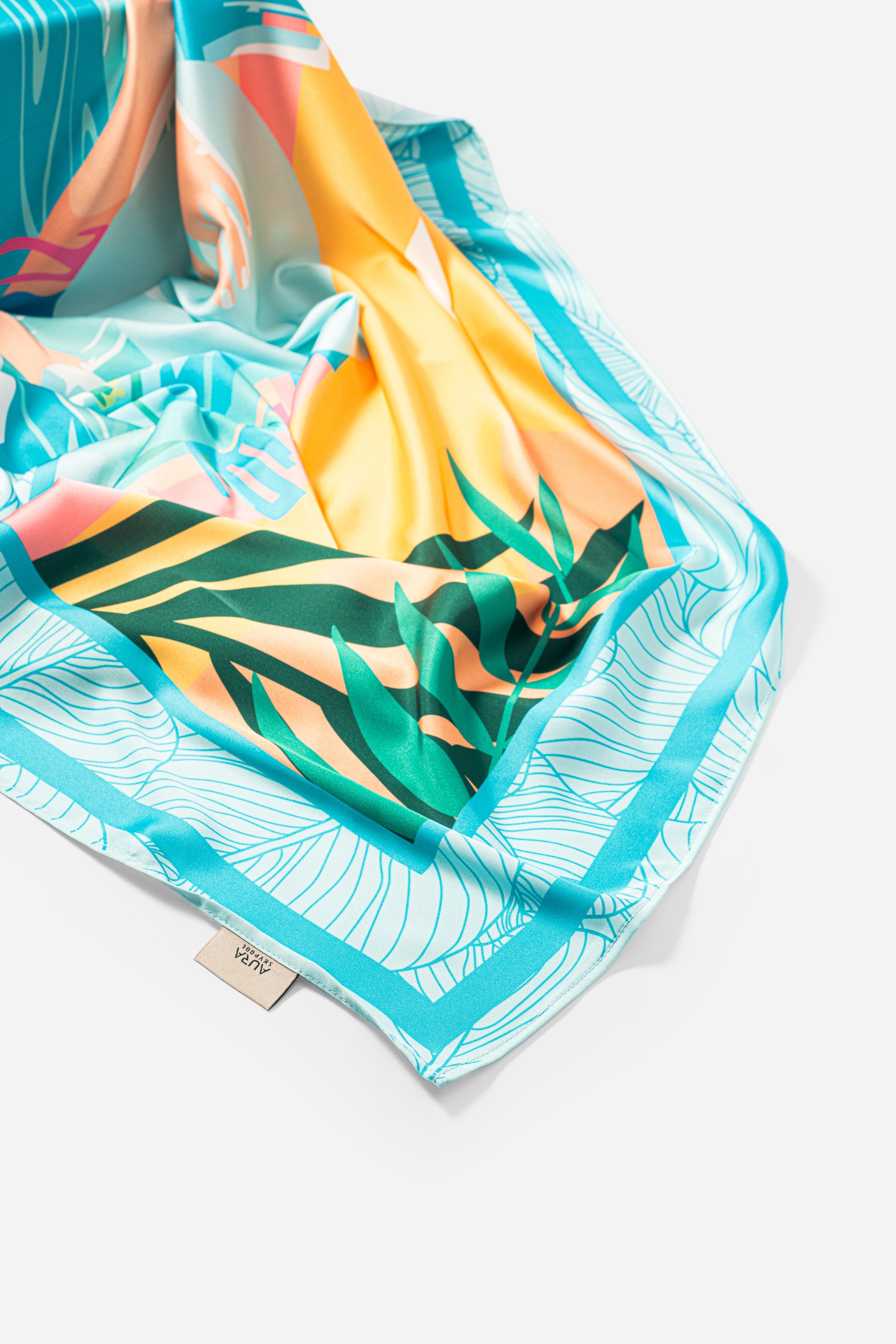 Dubai Skyline Silk Scarf in Sky Blue, draped close-up showing the AURA woven label