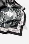 Monochrome Skyline Silk Scarf, draped close-up showing the AURA label and border print