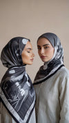 Monochrome Skyline Silk Scarf styled as hijabs on two models