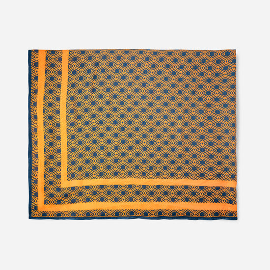 Monogram Sarong in Midnight Mirage, tube packaging front with AURA logo and geometric print