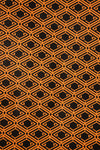 AURA Laptop Sleeve close-up of the orange and black monogram print pattern
