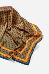 Monogram Silk Scarf in Midnight Mirage, bunched showing the reverse orange diamond print