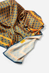 Monogram Silk Scarf in Midnight Mirage, bunched showing the AURA label and pale reverse
