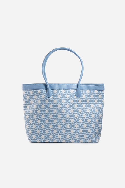 Front view of The Monogram Bag in Azure Blue with white and sky-blue geometric print and blue handles