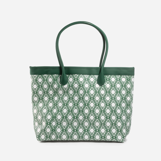 Front view of The Monogram Bag in Evergreen with white and green geometric print and green leather handles