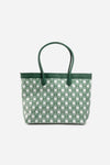 Front view of The Monogram Bag in Evergreen with white and green geometric print and green leather handles
